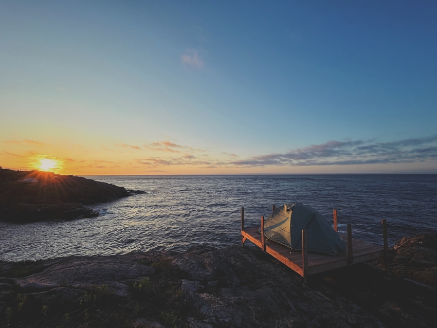 Camping tent on seaside during sunrise